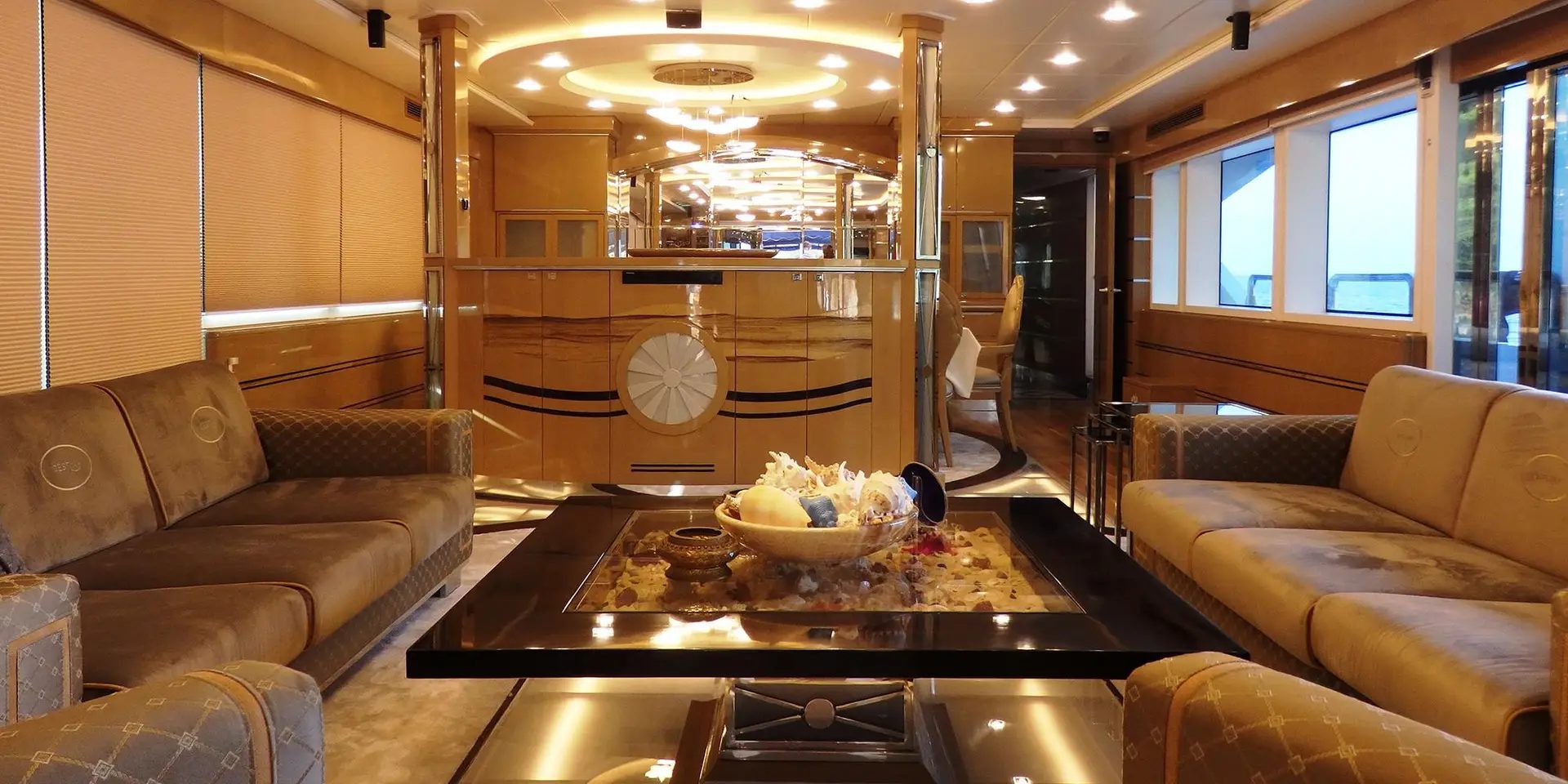 Main salon of M/Y DESTINY with lounge seating and timber panelling
