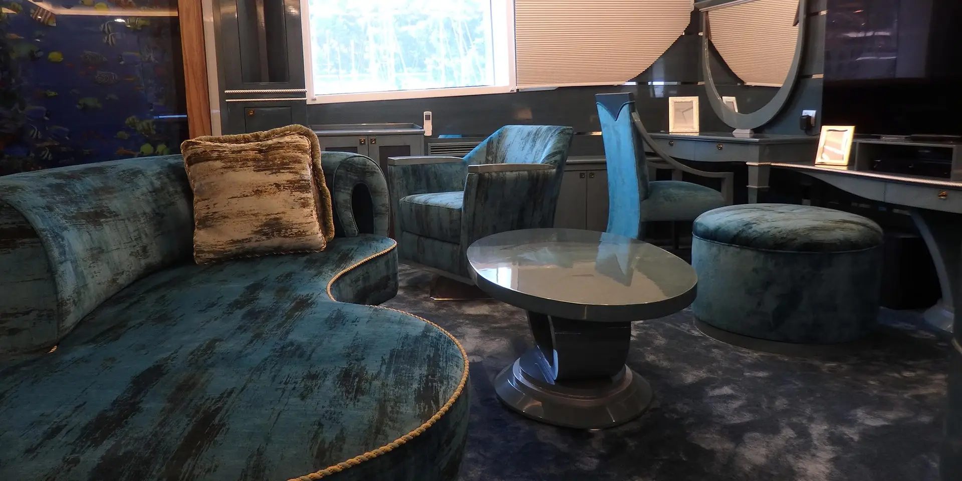 Private lounge on board M/Y DESTINY with blue upholstery and vanity area