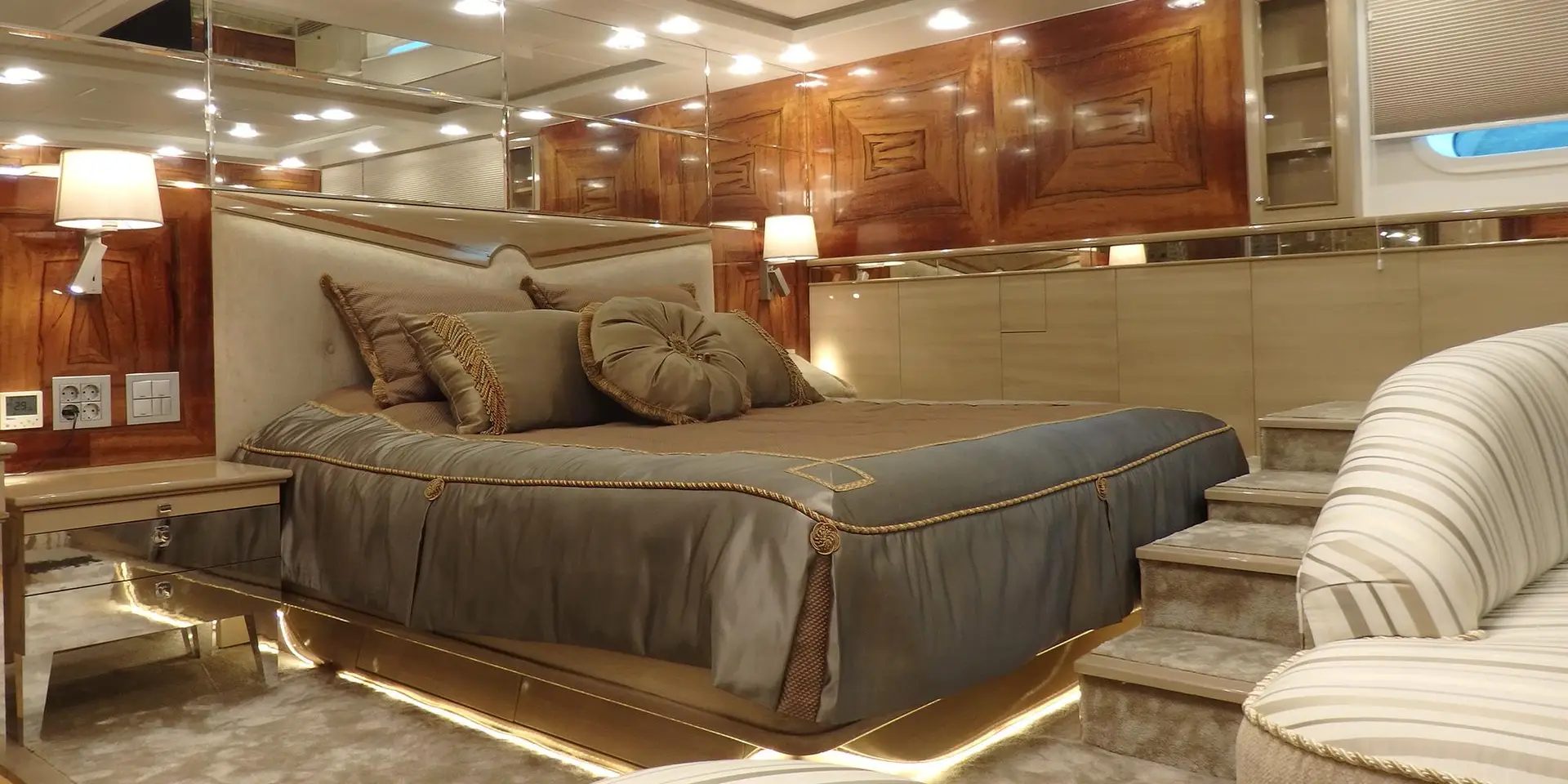 Guest cabin on board M/Y DESTINY with timber panelling and mirrored detailing